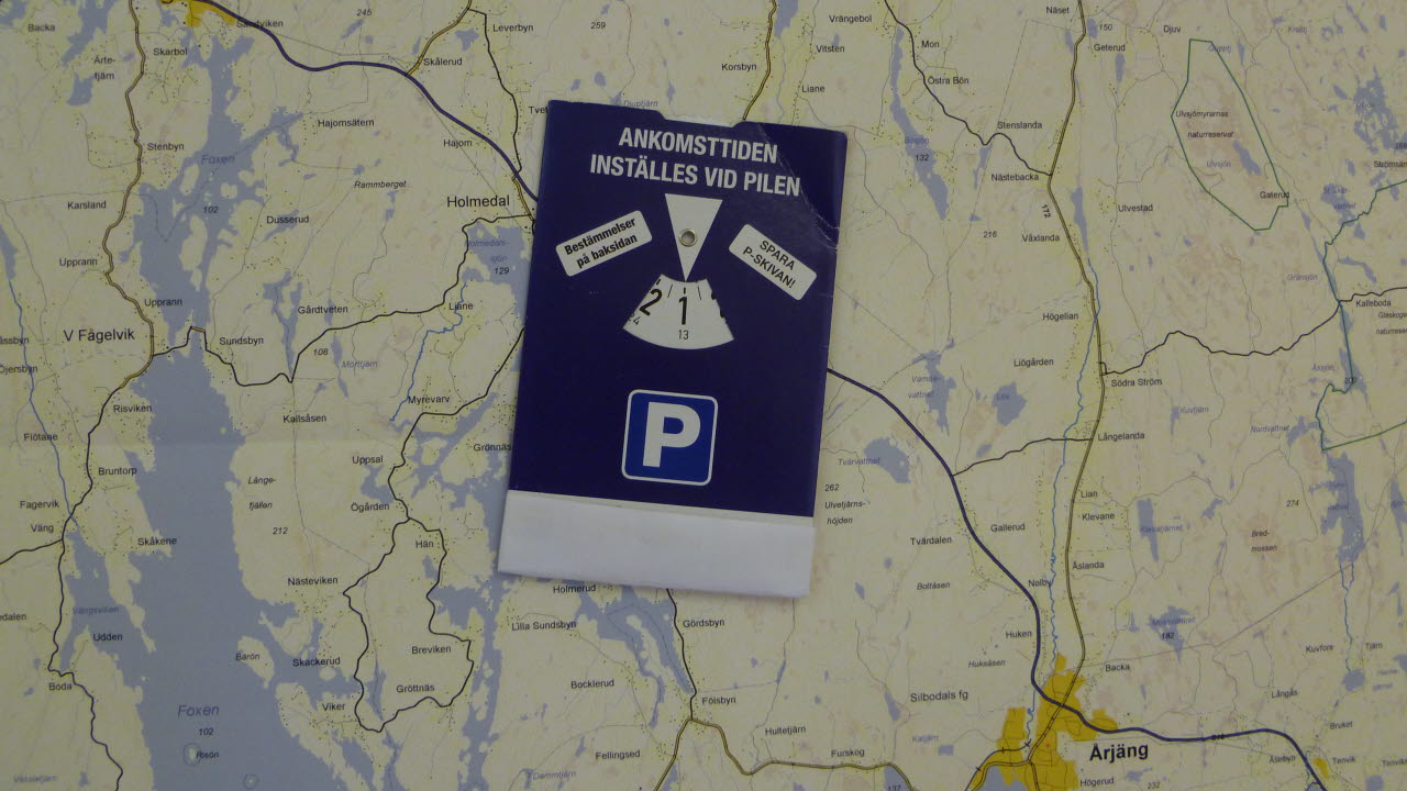 Parkeringsskiva som ligger på en kartbild
