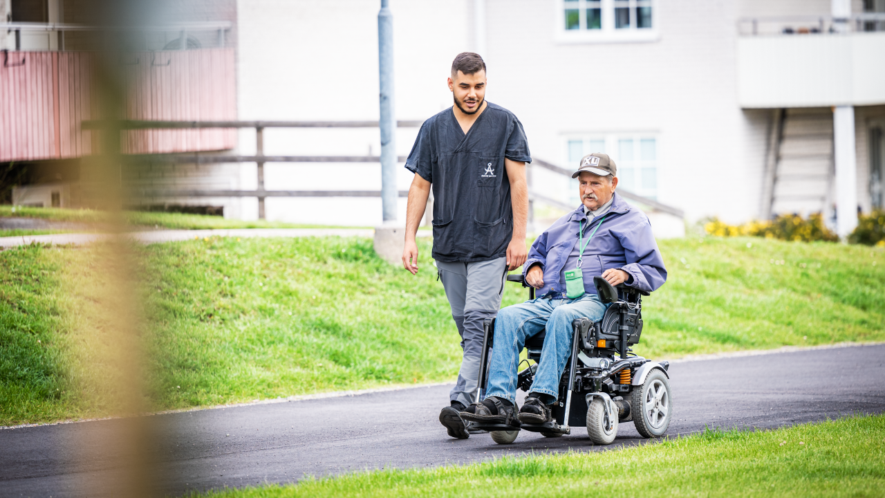 Medarbetare i hemtjänsten som följeslagare till man i permobil